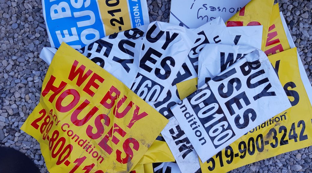 A pile of illegal signs collected from roadsides in Kitchener advertising business services