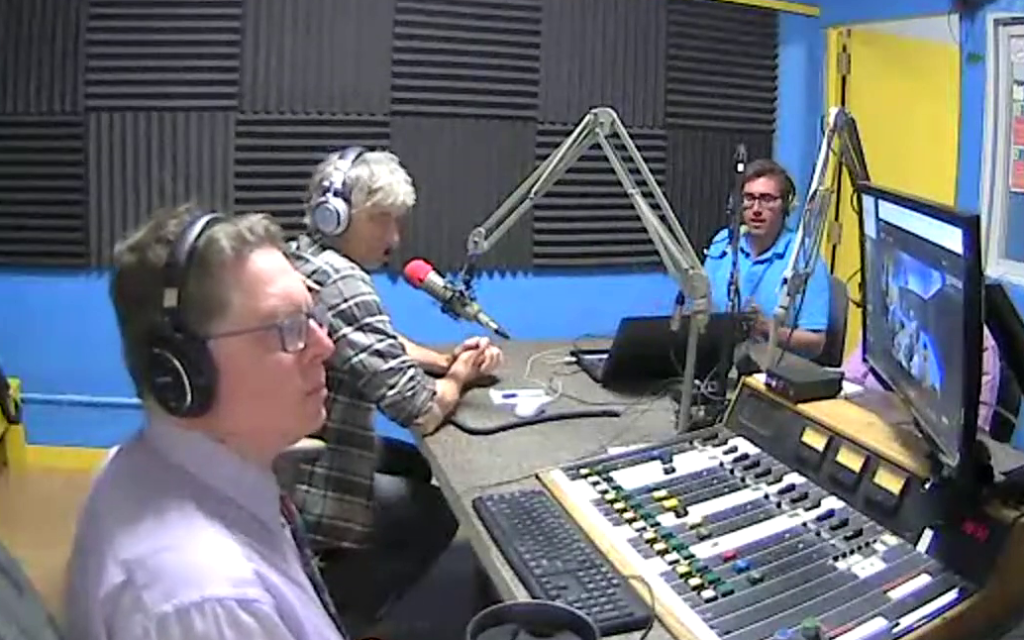 Bob Jonkman, Jeff Stager, and Brian Doucet in the studio at the microphones