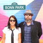 100 | Bonn Park (Sara Geidlinger and Marshall Ward standing in front of a colourfully painted brick wall, text above styled to look like a street name sign)