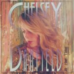 Chelsey Danfield (portrait of Chelsey Danfield in front of a glittery curtain)