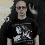 DJ Maciek (head & torso, wearing a black Bob Marley t-shirt, some random text in the left of the frame)