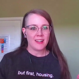 Dr. Erin Dej, wearing a T-Shirt with the words "but first, housing"