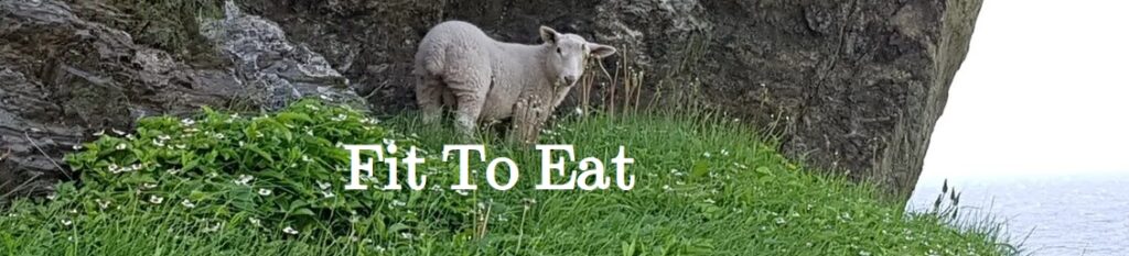 Fit To Eat (white letters over a picture of a cliff-side meadow with a sheep looking into the camera)