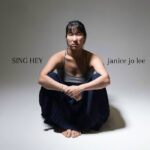 Sing Hey | Janice Jo Lee (photo of Janice Jo Lee sitting on the floor)