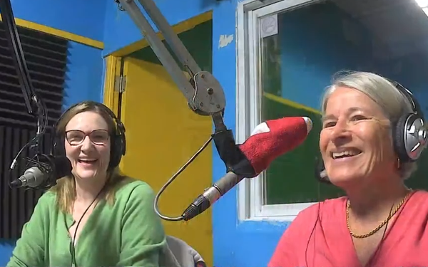 (Rowena Samuel and Alison Watson sitting a the microphones in the CKMS-FM studio)