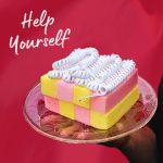 Help Yourself (a pink and yellow cake with whipped cream on a plate)