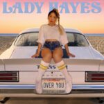 Lady Hayes | Over You (Shelley Hayes sitting on the trunk of a TransAm, "Over You" is the license plate)
