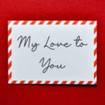 My Love To You (handwriting on an airmail envelope lying on a red background)