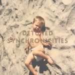 Detuned Synchronicities (a baby wearing a diaper laying on the beach)