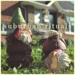 Suburban Rituals (closeup of two garden gnomes)