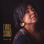 I Will Stand | Tania Joy (portrait of Tania Joy on a dark background)