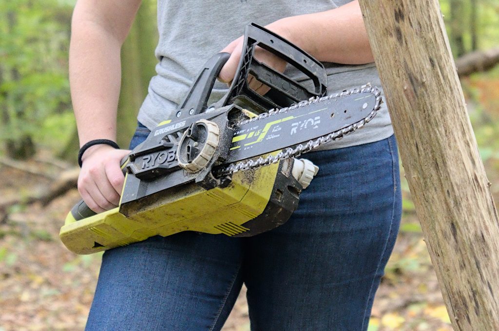 Woman posing with a Ryobi battery-powered chainsaw in Bois de Roly, Belgium