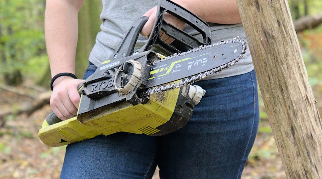 Woman posing with a Ryobi battery-powered chainsaw in Bois de Roly, Belgium